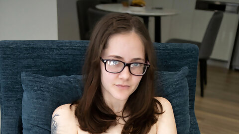 Petite MILF in glasses Eva May strips naked & spreads her inviting hairy pussy